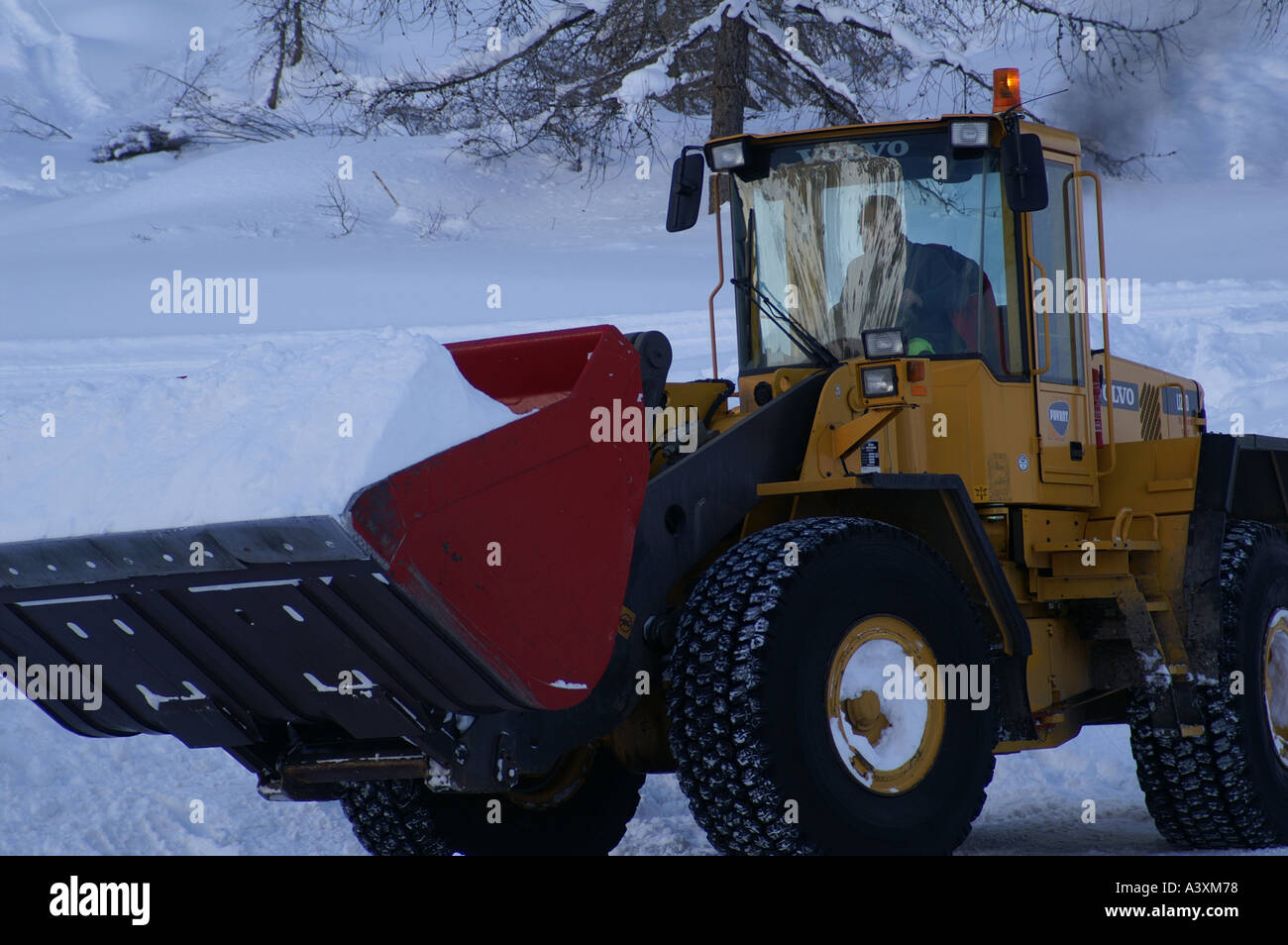 On the Volvo snow clearing in Val D'Isere Jan 2005 neige poudre Tarentaise Savoie France Stock Photo