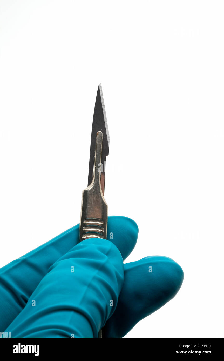 scalpel  blade gloved hand, cosmetic Surgery Stock Photo