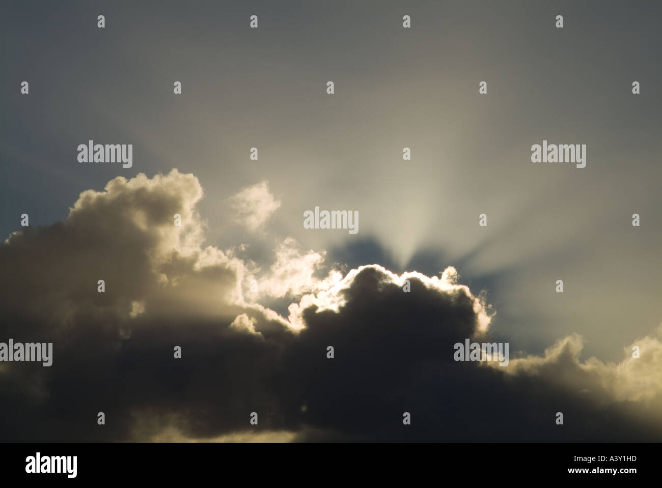 dh storm clouds CLOUDS BACKGROUND Black and grey sunlight from white sun stormy sky uk backlit cloud sunbeam moody rays silver lining Stock Photo