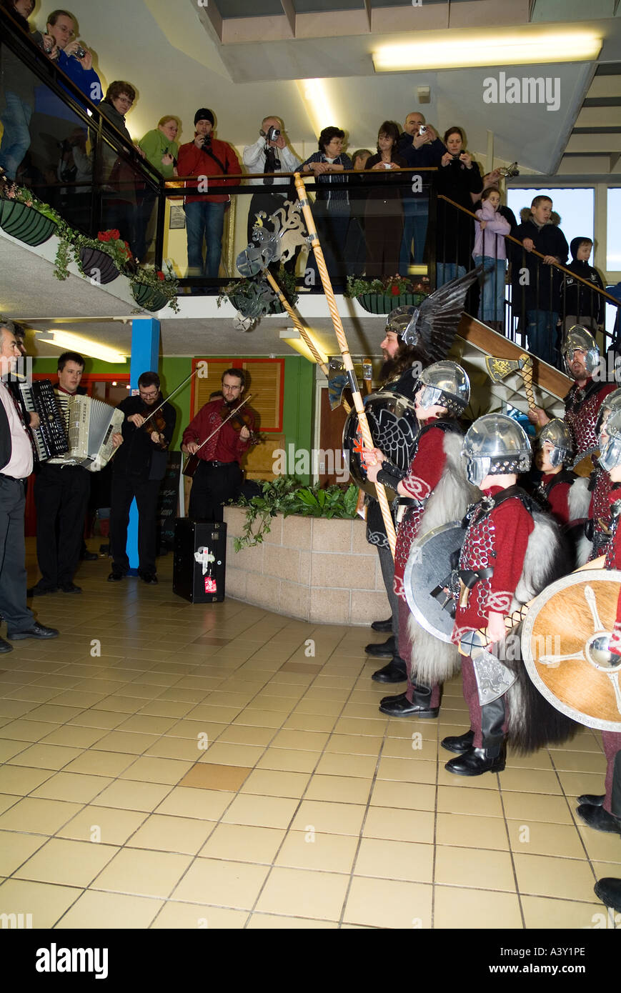 dh Up Helly Aa procession LERWICK SHETLAND Jarl Einar of Gullberuvik and sqaud singing at shopping centre tradition Stock Photo
