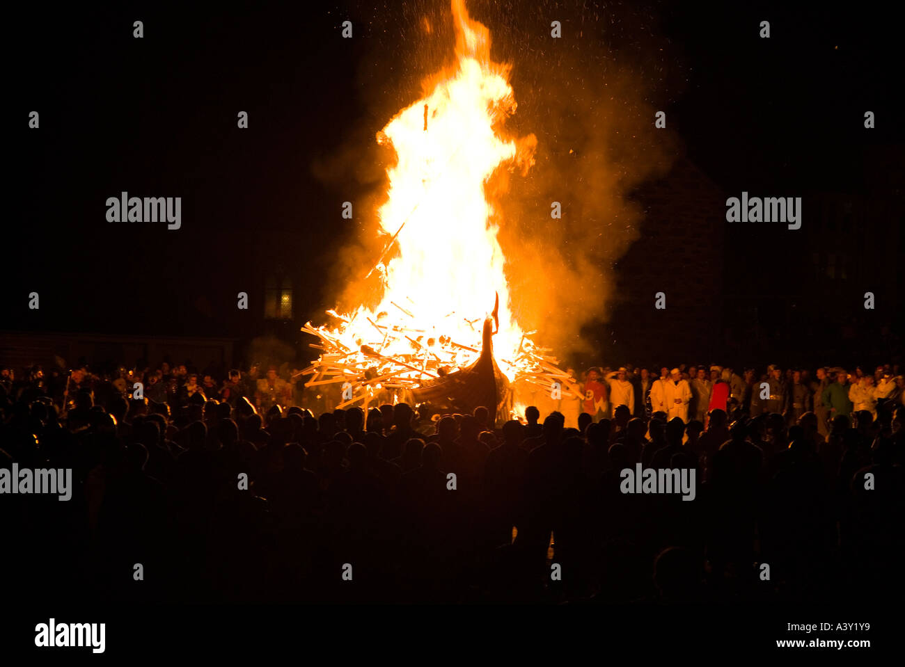 dh Up Helly Aa fire procession LERWICK SHETLAND Guizers watching Viking longship galley Moogi alight at burning site festival shetlands boat Stock Photo