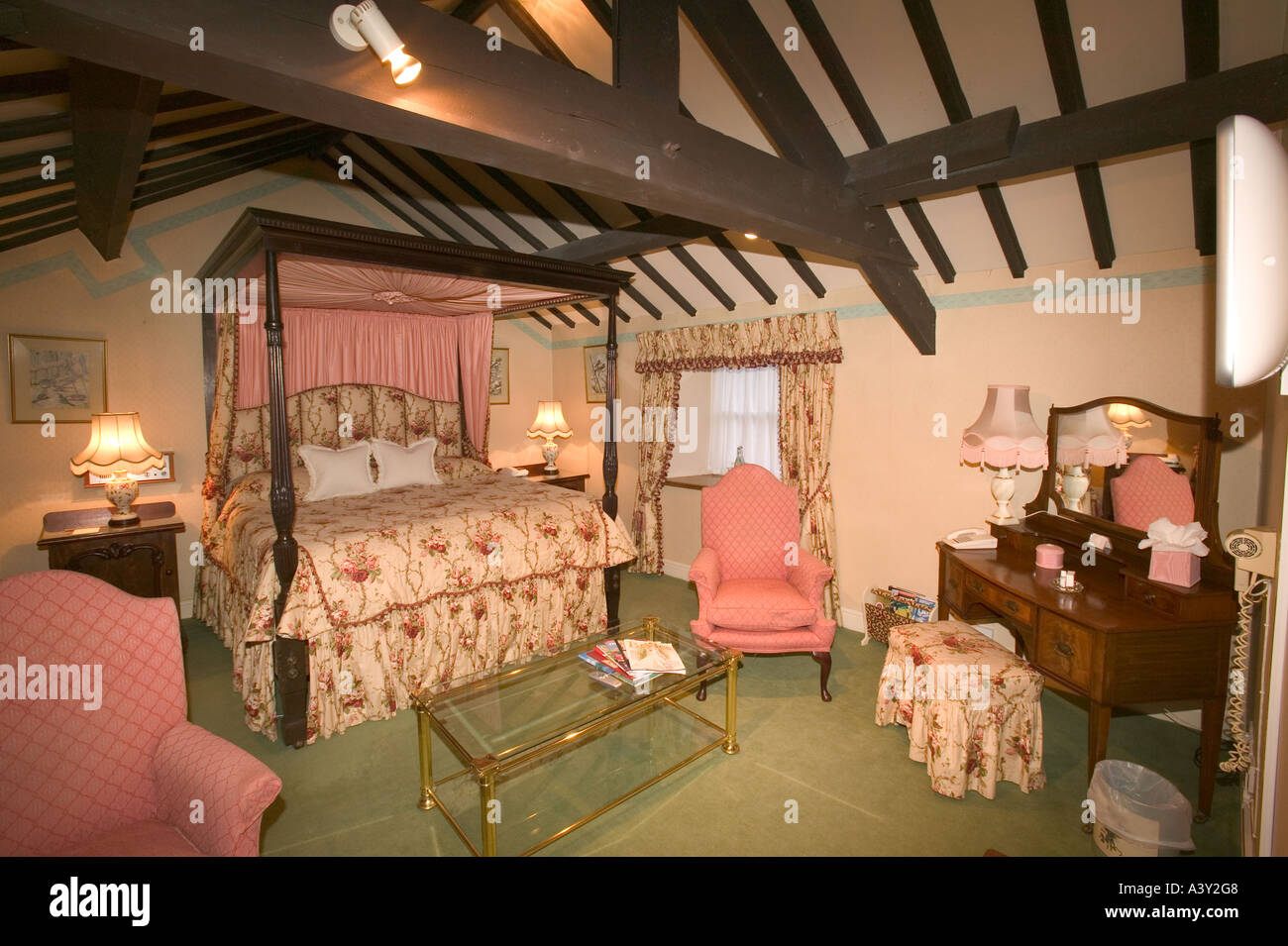 a room with a four poster bed in the Wordsworth Hotel, Grasmere, Lake district, UK Stock Photo