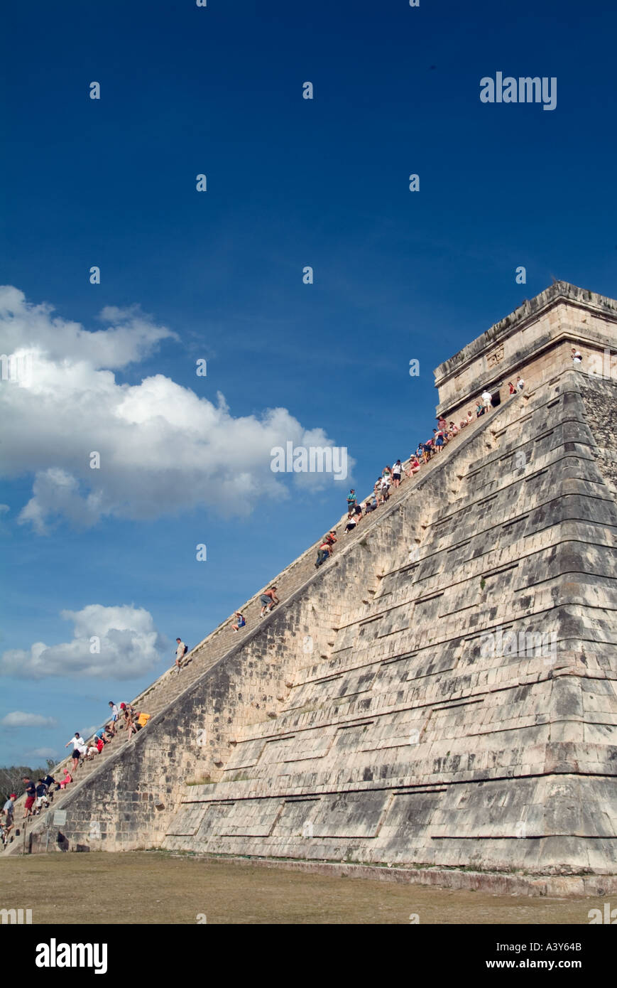 Corner view tourists climbing Pyramid of Kukulcan Chichen Itza Mexico