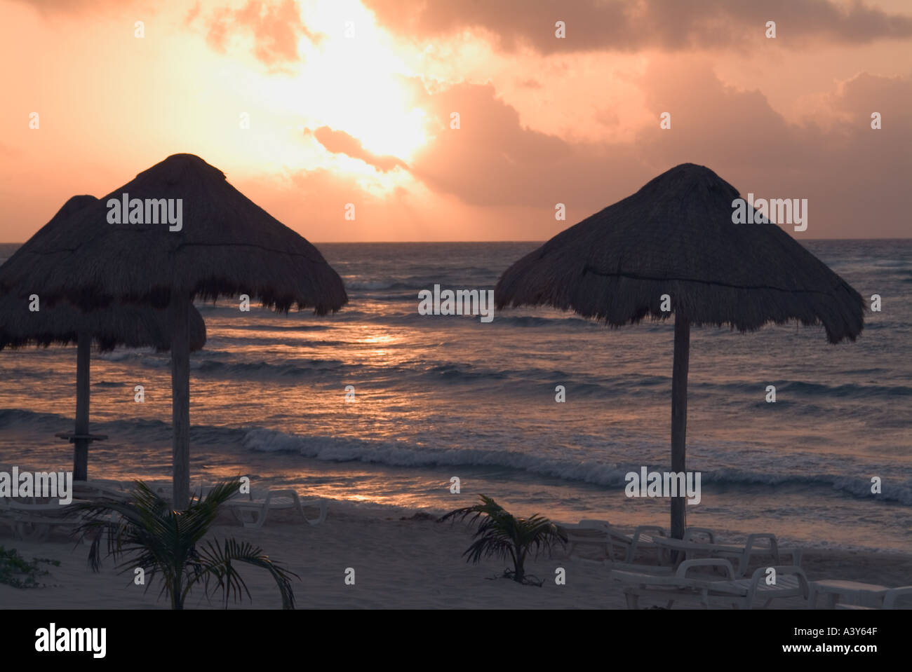 Mexican beach sunset straw umbrellas Riviera Maya Mexico Stock Photo