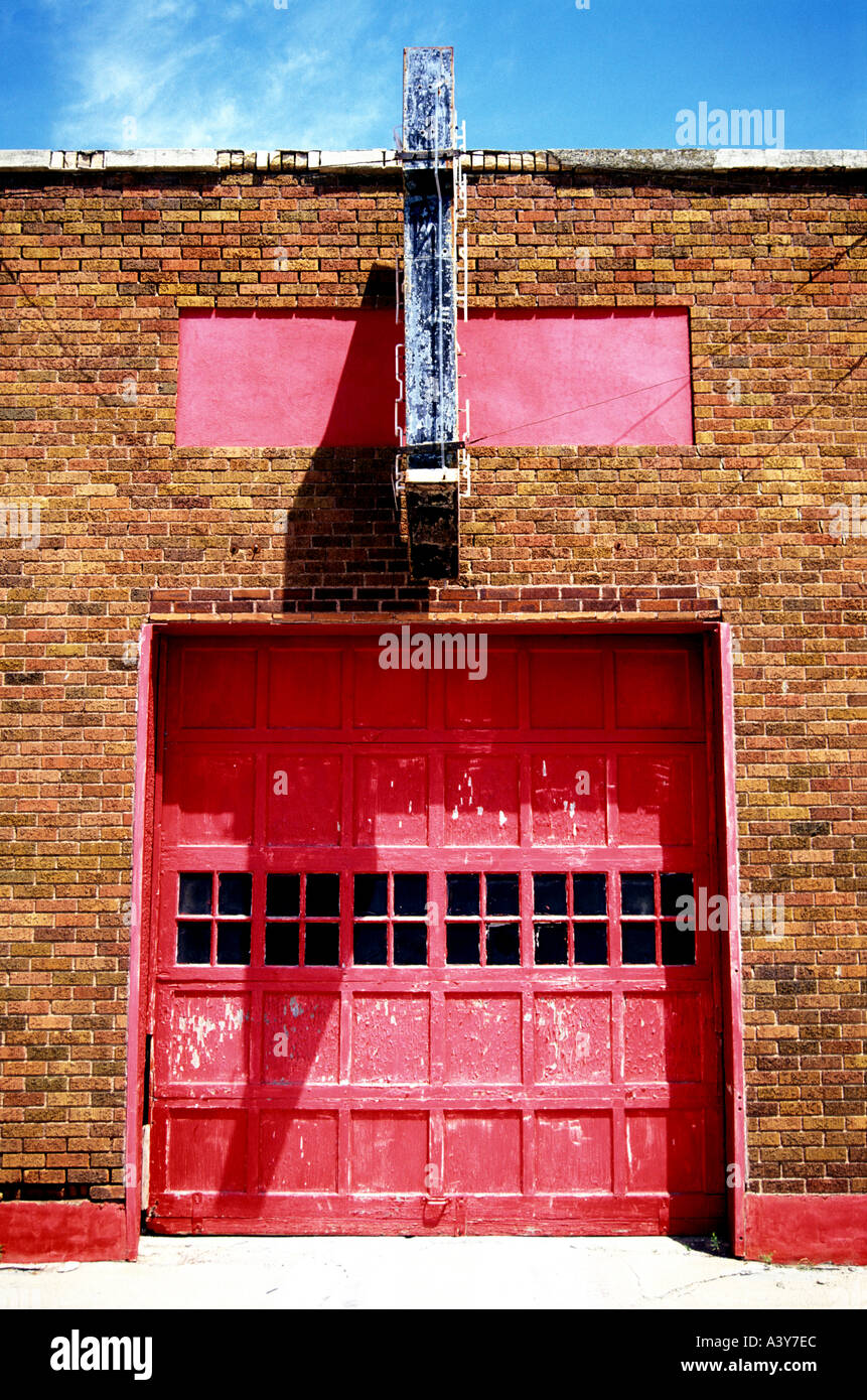 USA South Dakota Britton Old shop with a red roller door and arrow sign