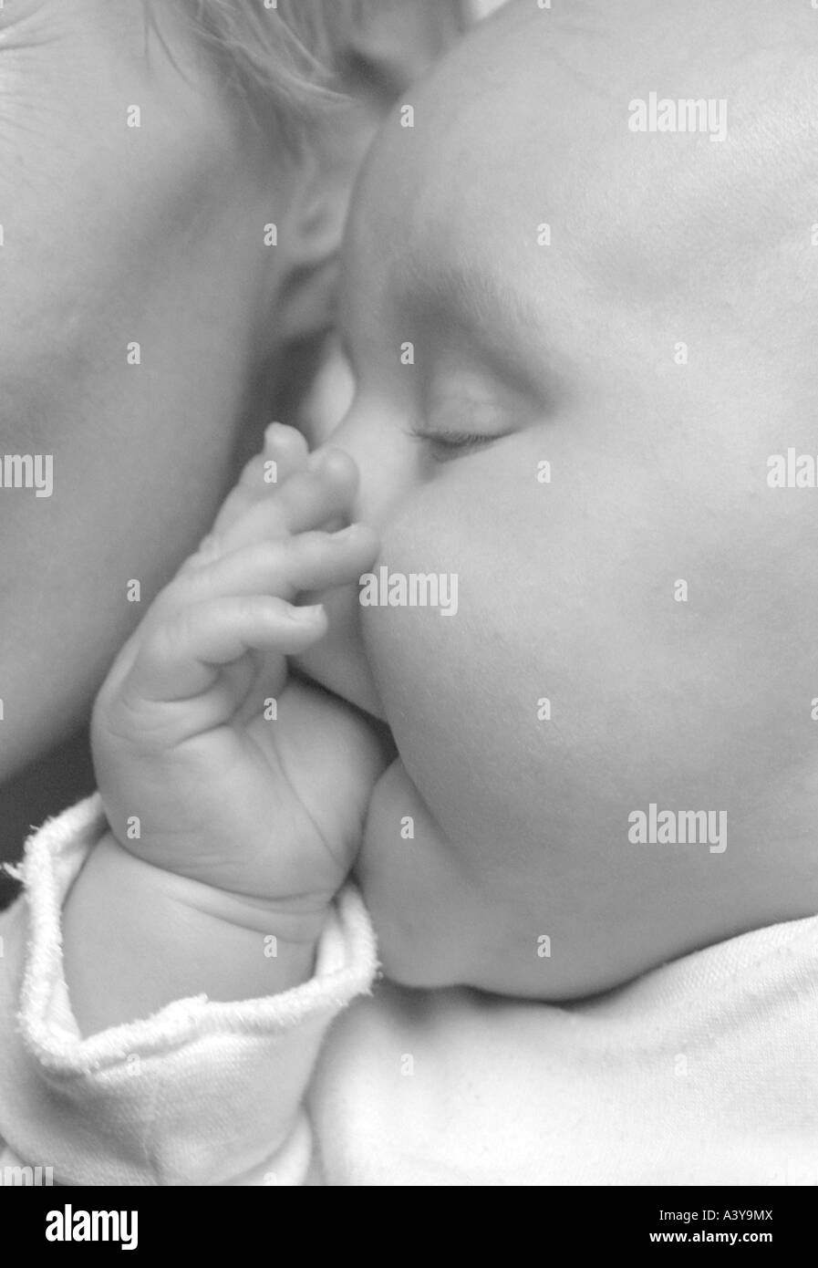 people, human beings, humans (Homo sapiens sapiens), baby sucking at his thumb, with eyes closed Stock Photo