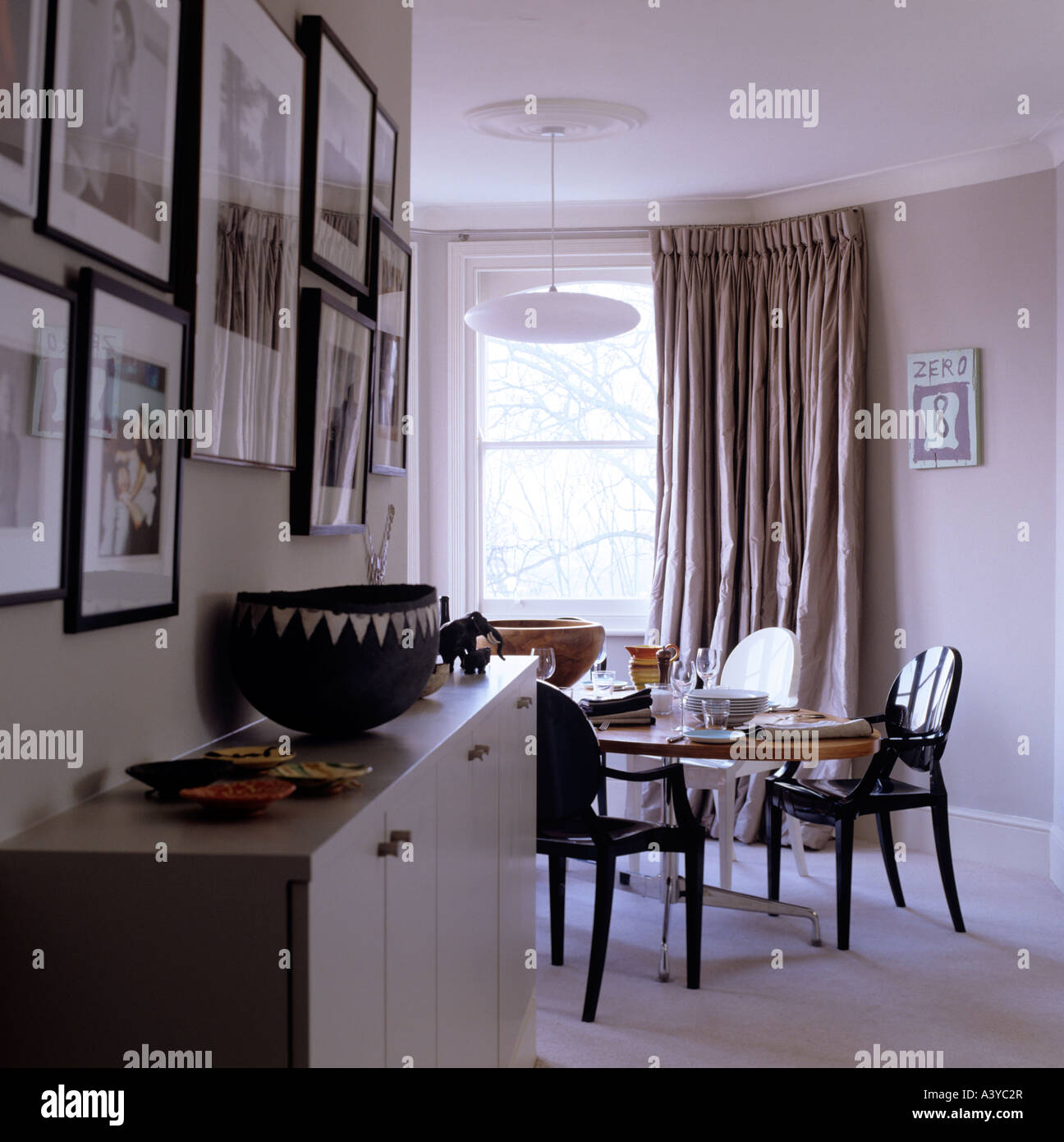 View of a sideboard and dining table in contemporary London apartment Stock Photo