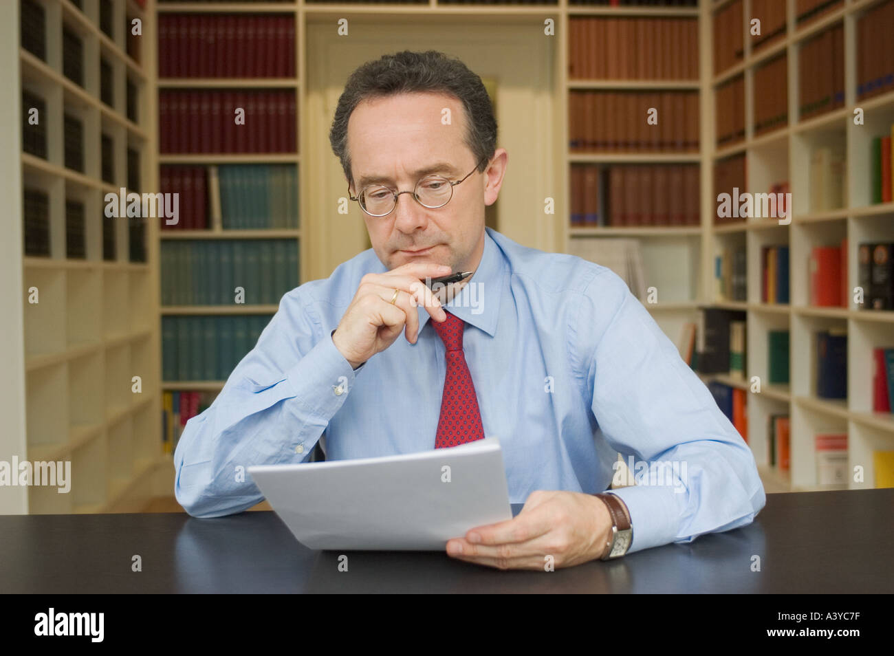 MR lawer reading a contract in the office Stock Photo