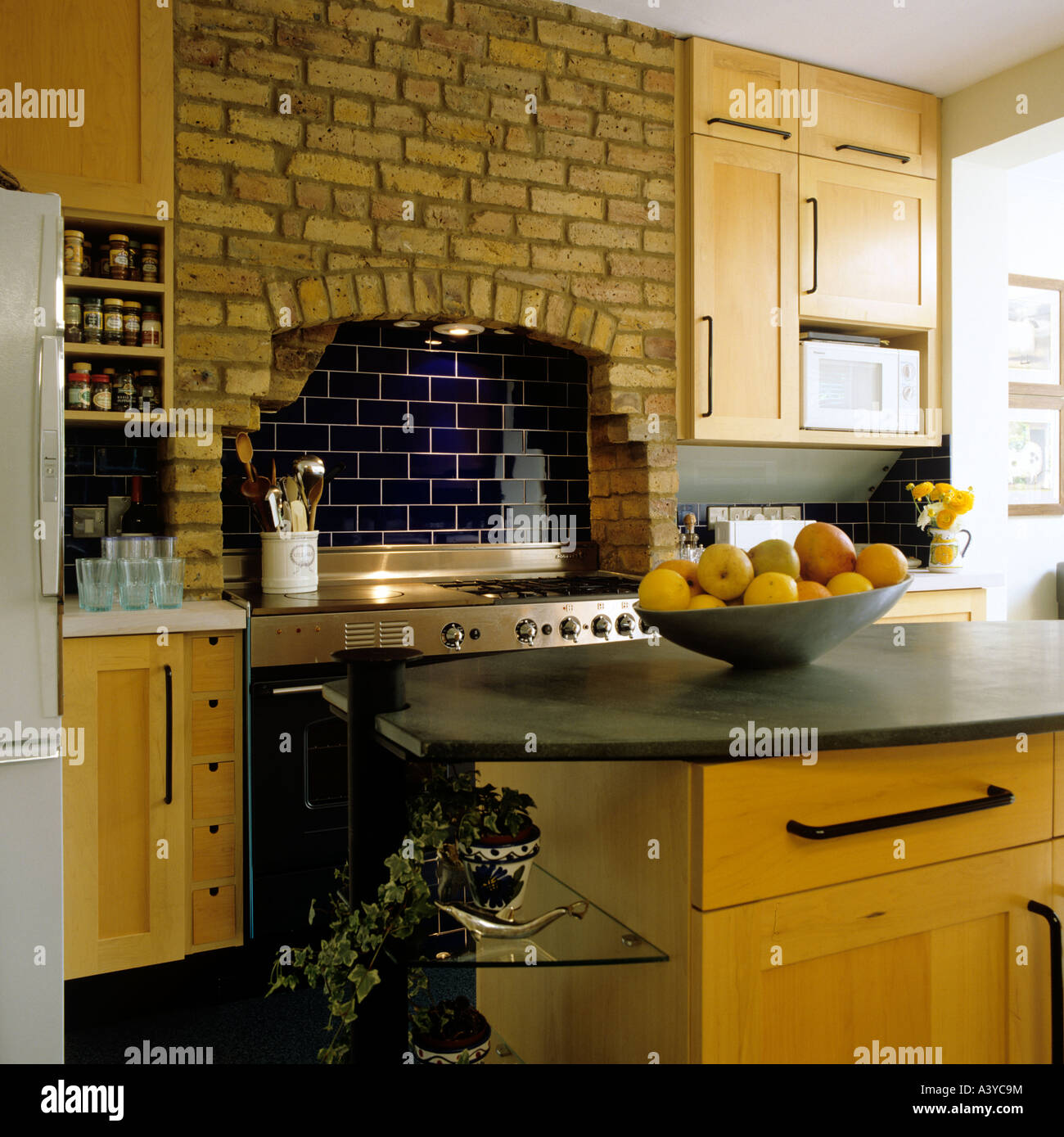 Kitchen featuring an island and exposed brickwork Stock Photo