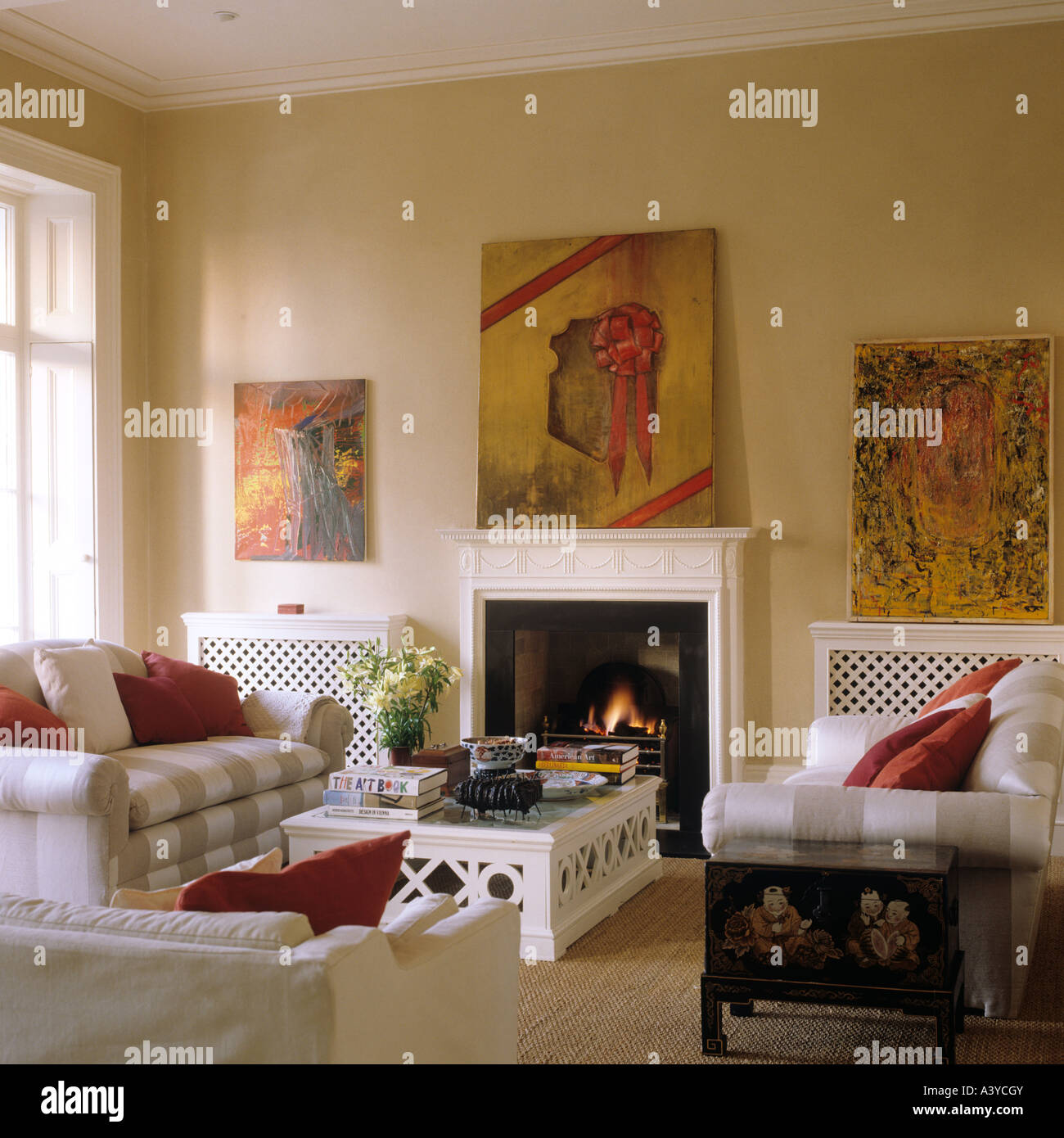 drawing room with fireplace and modern paintings Stock Photo - Alamy