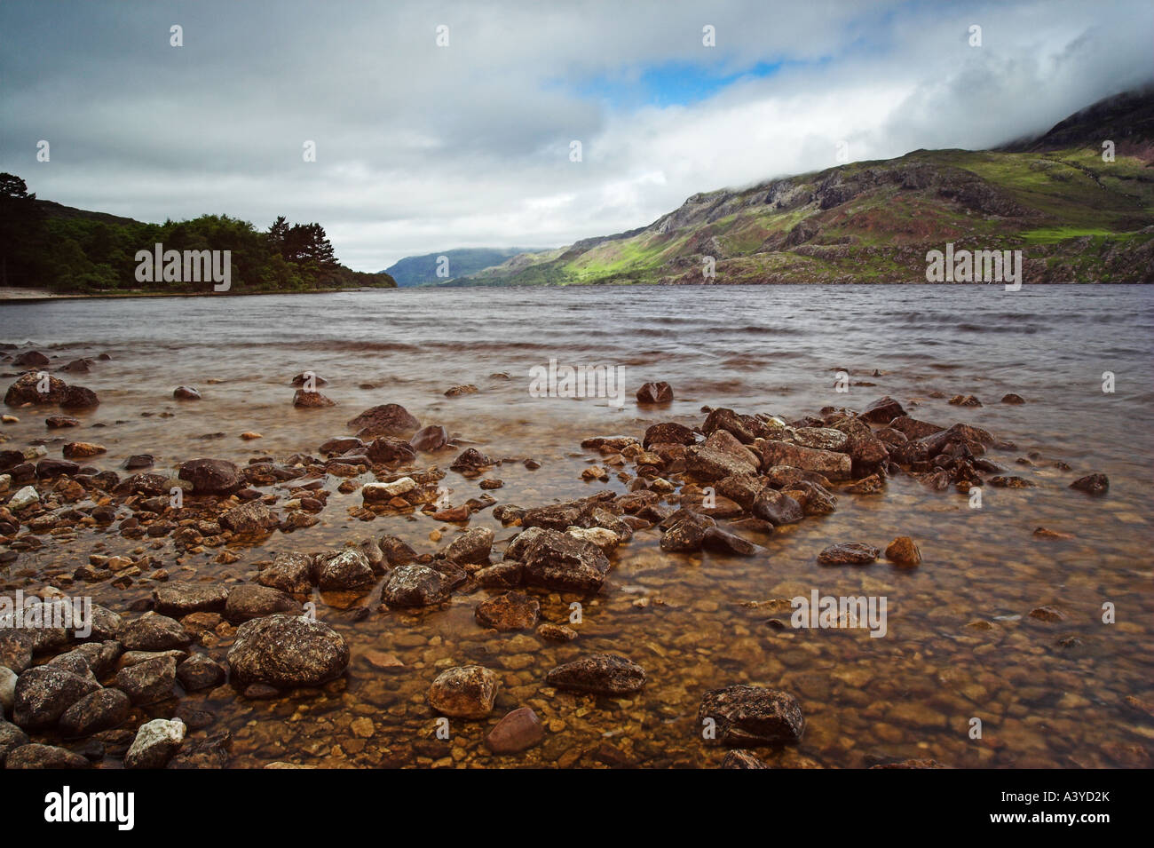 Loch Maree, West Scottish Highlands with foreground rocks and pastel skies. Stock Photo