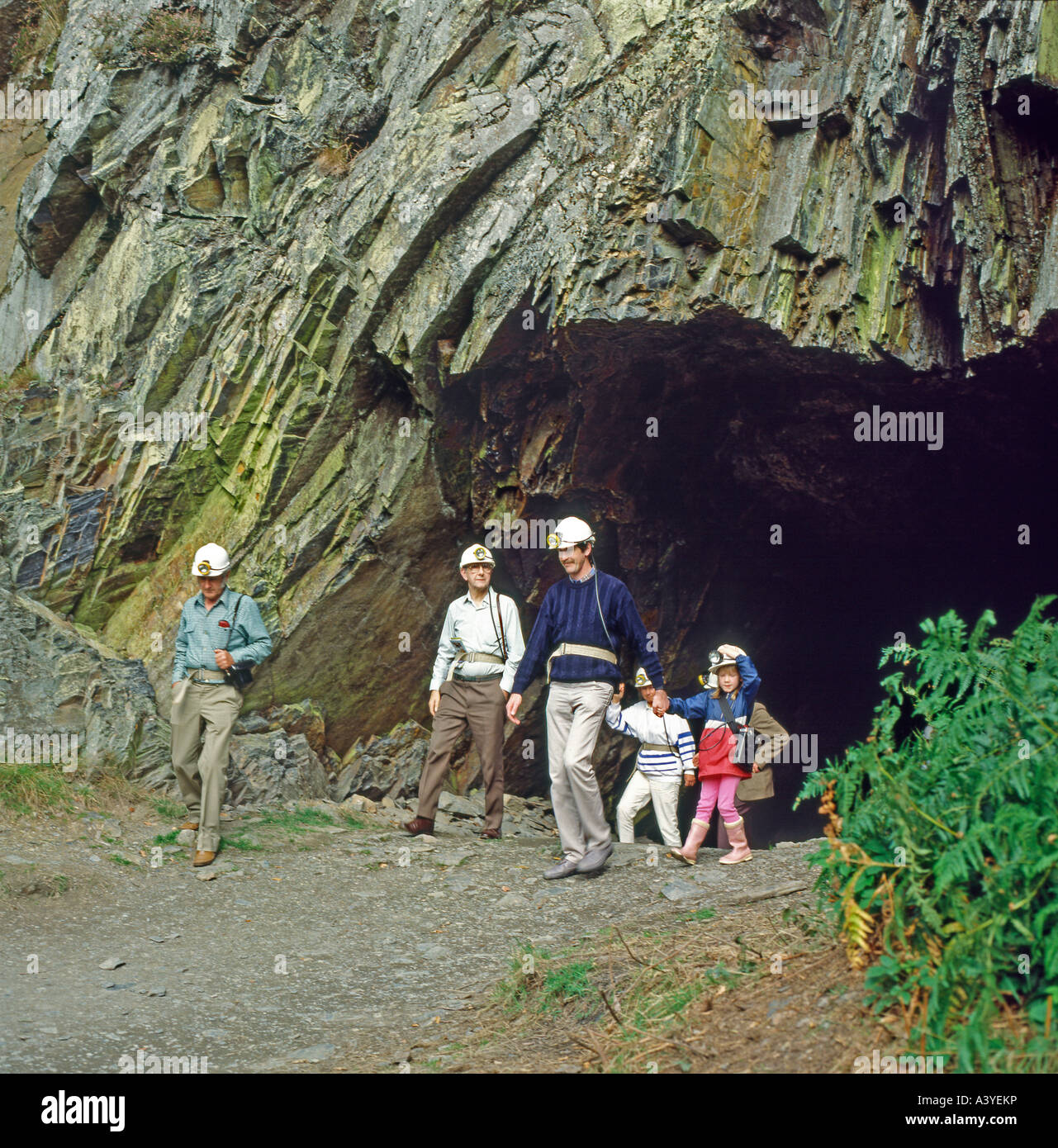 Family of visitors tourists outside an adit a cave at the Dolau Cothi Gold Mine in Pumpsaint, Llanwrda, Wales, UK  KATHY DEWITT Stock Photo