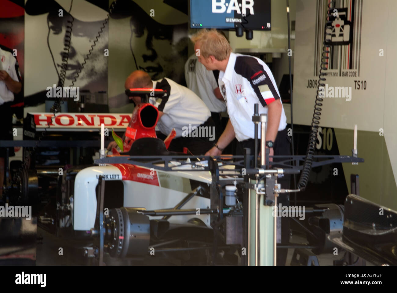 Formula 1 racing car pit lane front garages honda bar mechanics Gilles