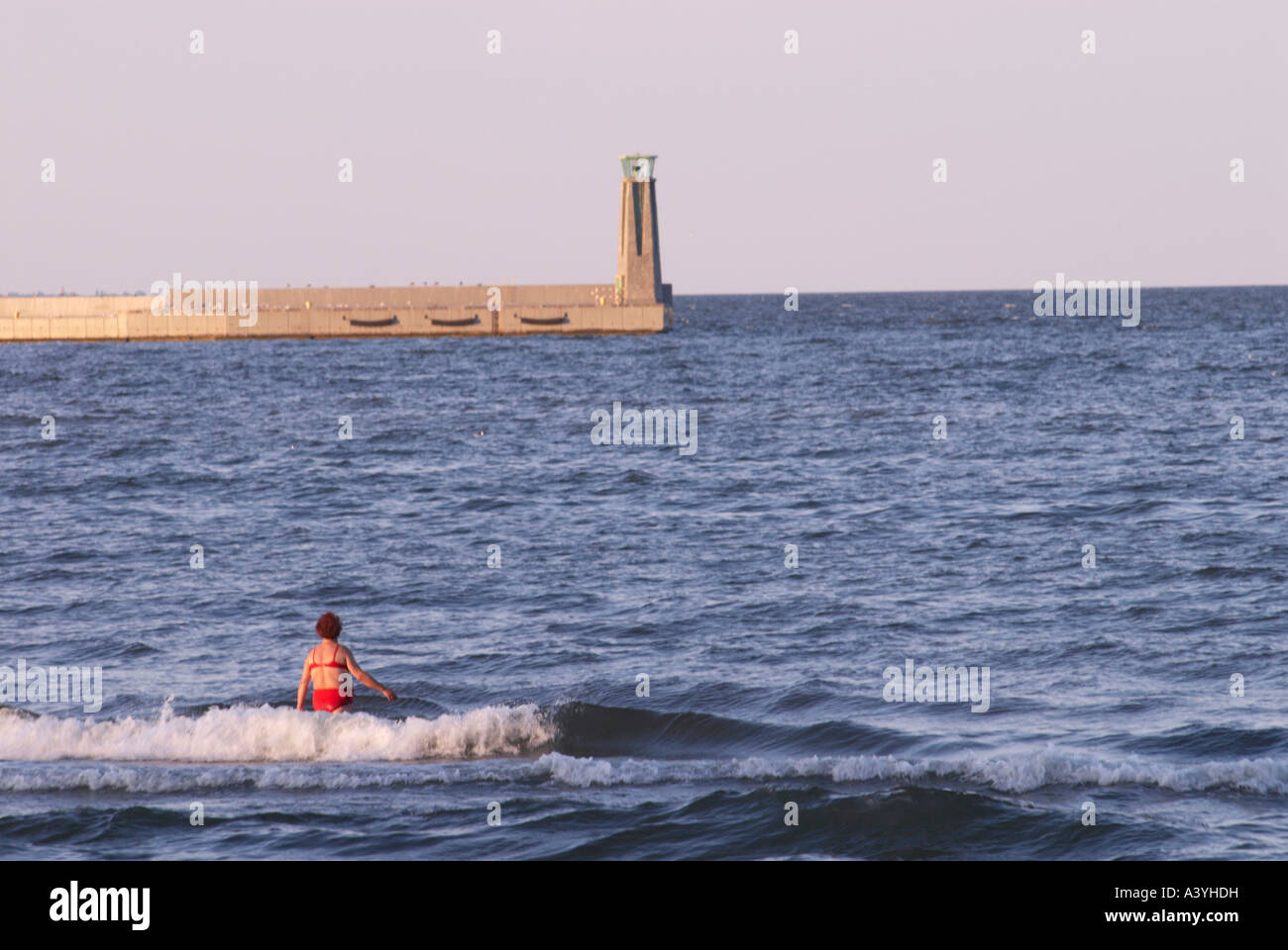 Lone swimmer entering the sea Stock Photo