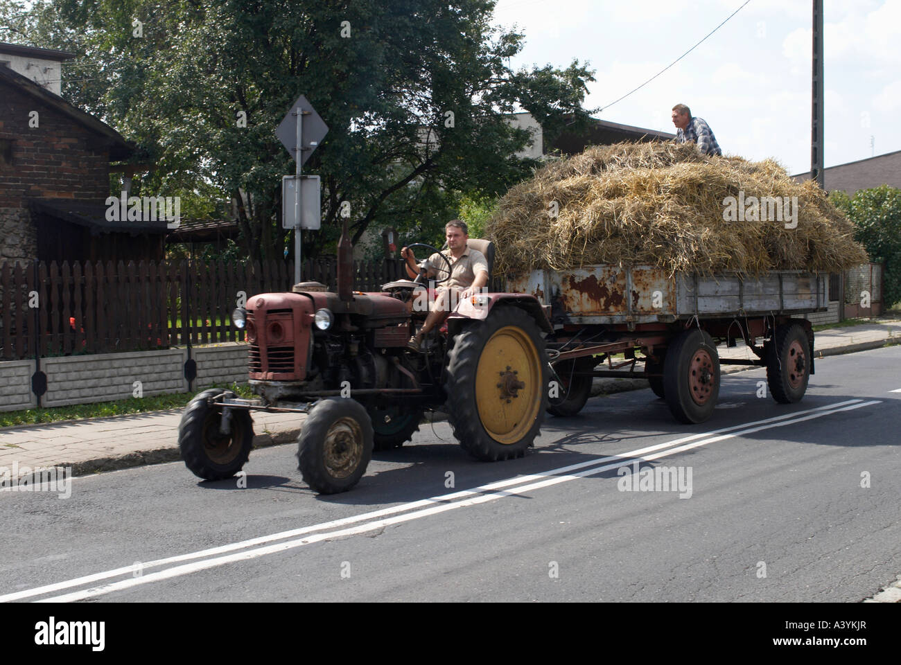 A tractor pulling a trailer of hay Stock Photo Alamy