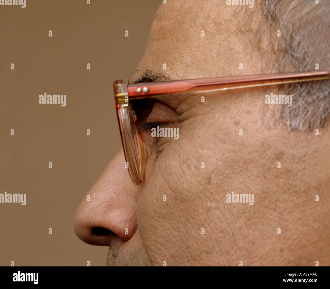 close up of mature man wearing horn rimmed glasses Stock Photo