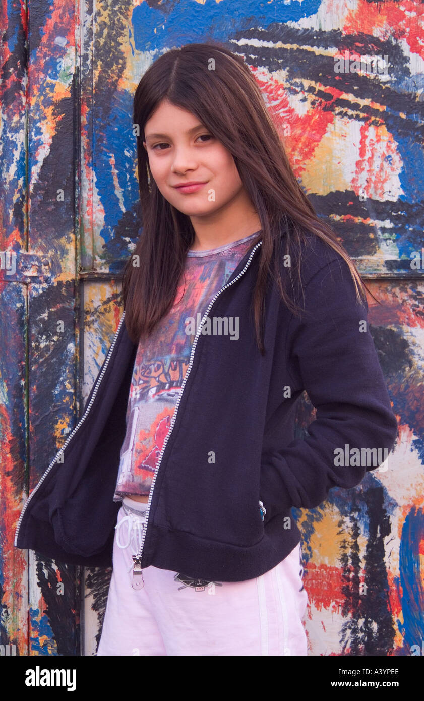 A sophisticated cool-looking long haired 9 year old girl looking far older than her years. Stock Photo