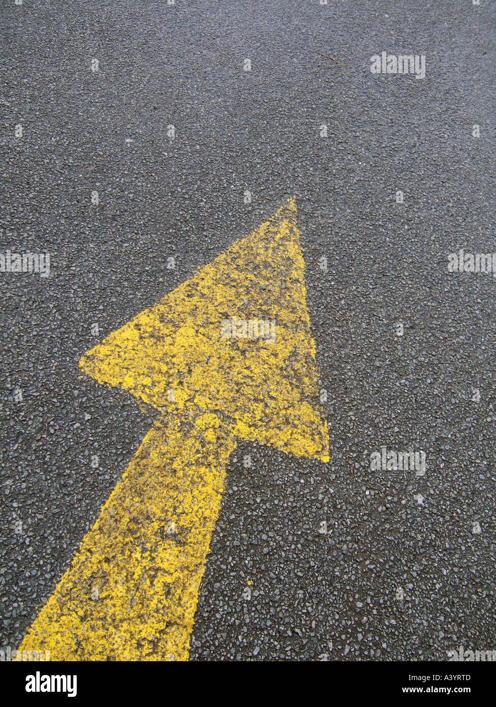 yellow arrow on road Stock Photo - Alamy