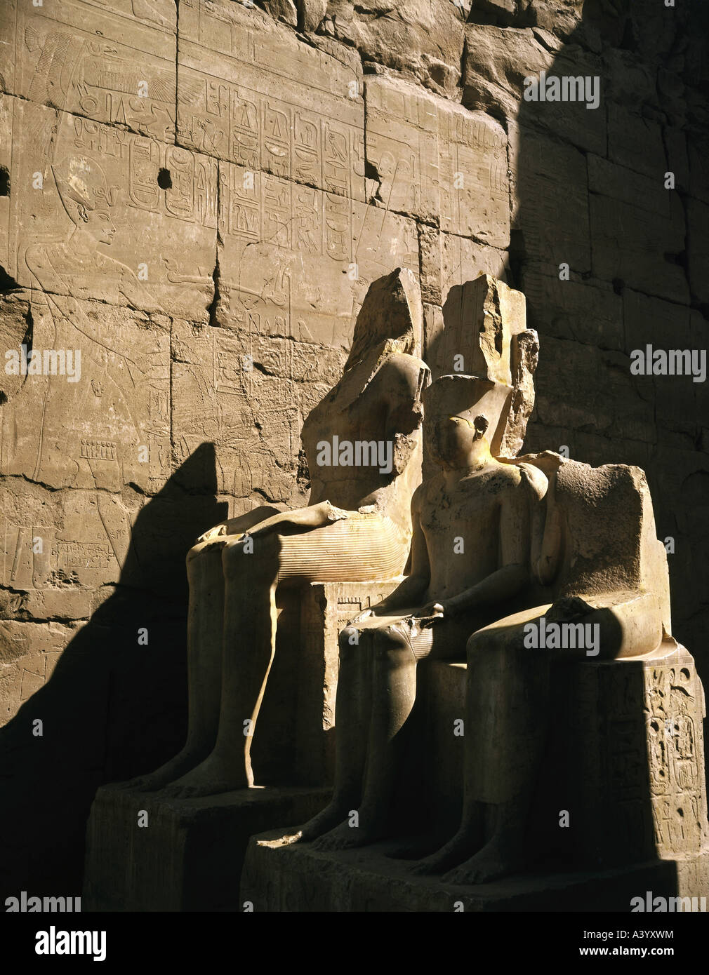 travel /geography, Egypt, Luxor, buildings, temple, Theban divine family Amun, Mut, Chons, exterior view, statue, rulers of 18th dynasty, architect Amenhotep son of Hapu, 1402 - 1364 B.C., extensions under Ramesses II, 1303 - 1236 B.C., historic, historical, Africa, architecture, temples, ancient world, New Kingdom, 18th / 19th dynasty, 15th - 13th century B.C., sculpture, sculptures, statues, sitting, child, ancient world, Stock Photo
