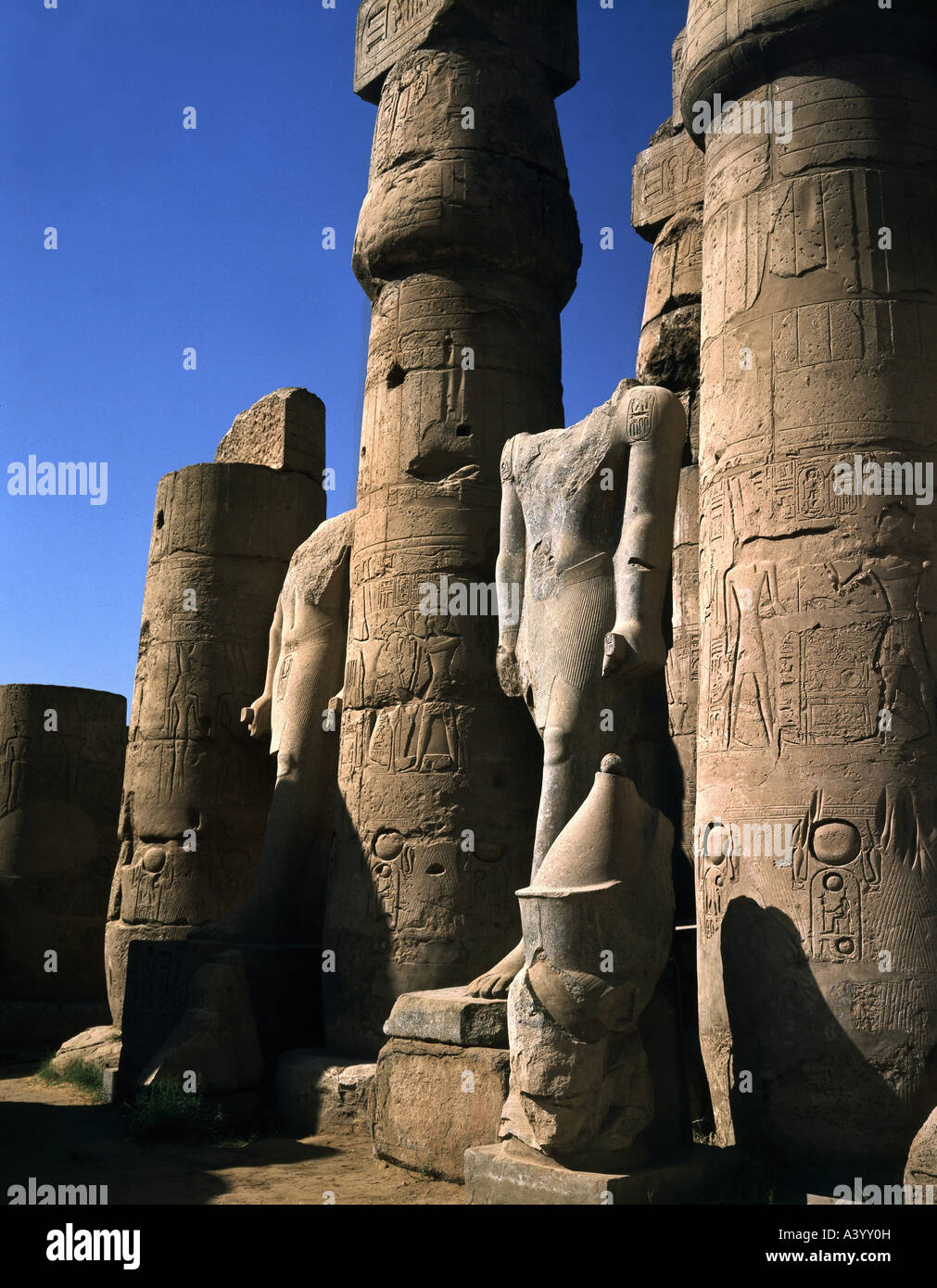 travel /geography, Egypt, Luxor, buildings, temple, Theban divine family Amun, Mut, Chons, exterior view, temple of Ramesses II, southern part, statues of pharaoh Amenhotep III, architect Amenhotep son of Hapu, 1402 - 1364 B.C., extensions under Ramesses II, 1303 - 1236 B.C., historic, historical, Africa, architecture, temples, ancient world, New Kingdom, 18th / 19th dynasty, 15th - 13th century B.C., column, columns, statue, sculpture, sculptures, ancient world, Stock Photo