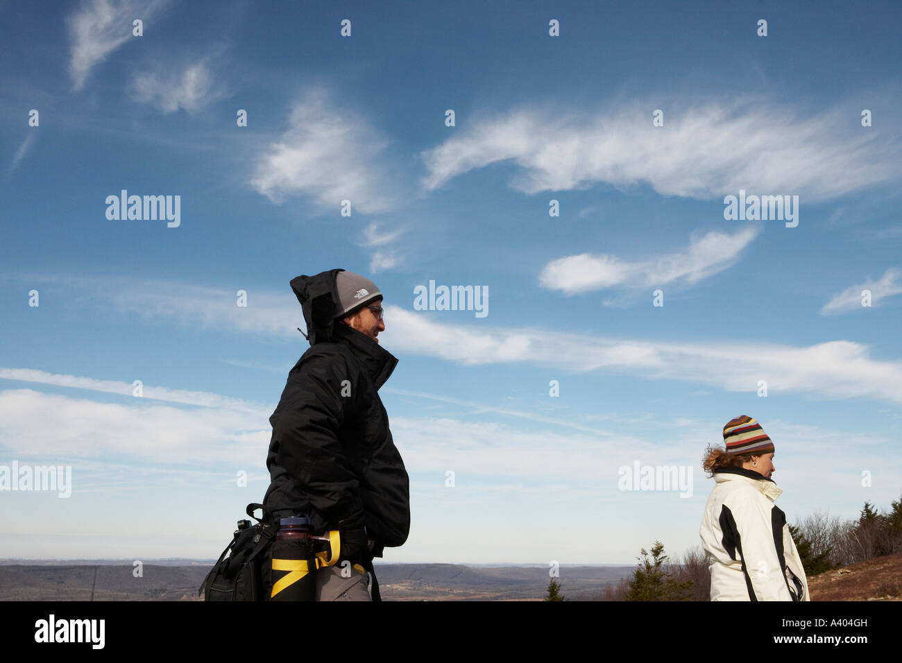 Two hikers on a mountain top Stock Photo