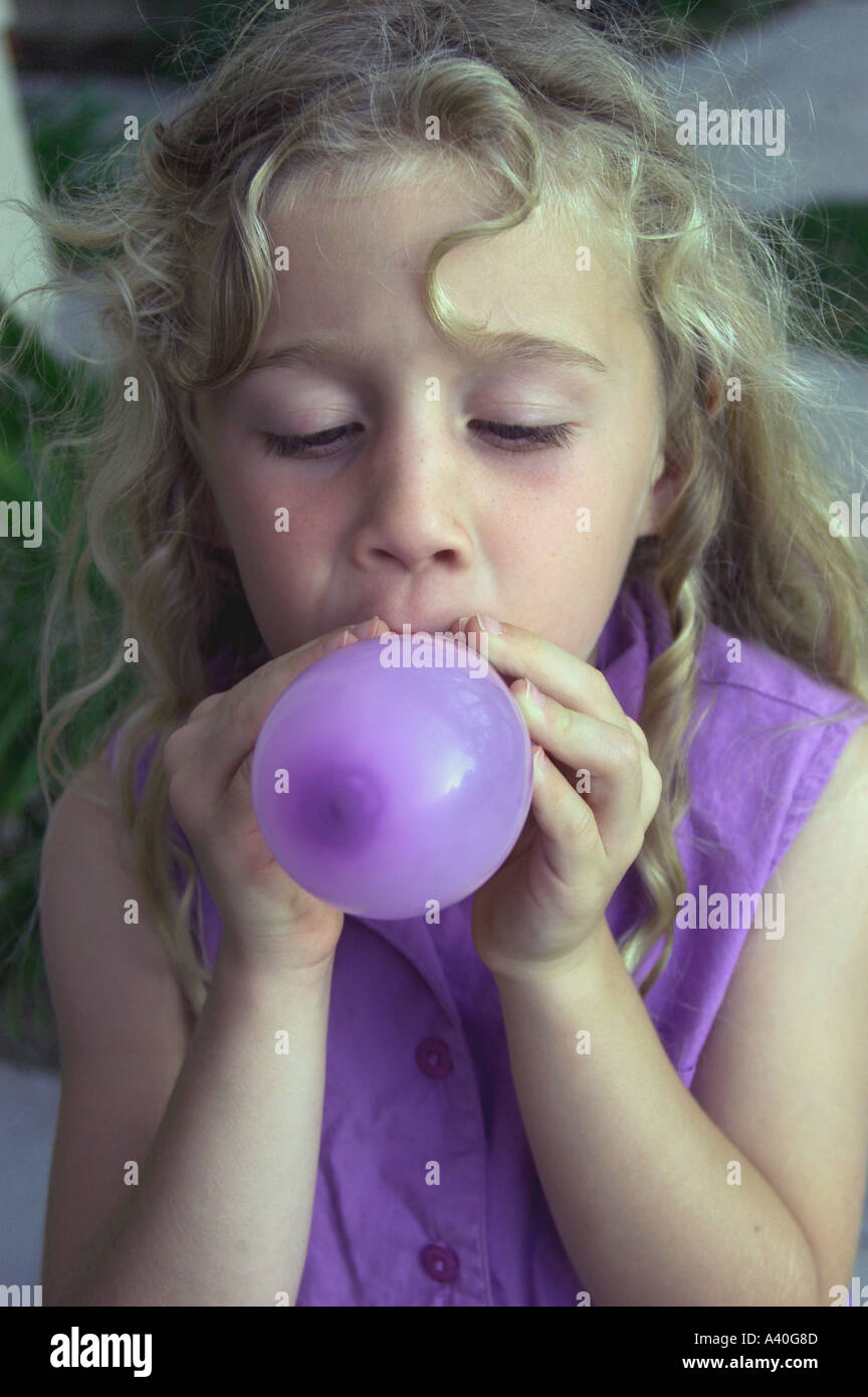 Portrait girl blowing up balloon hi-res stock photography and images ...