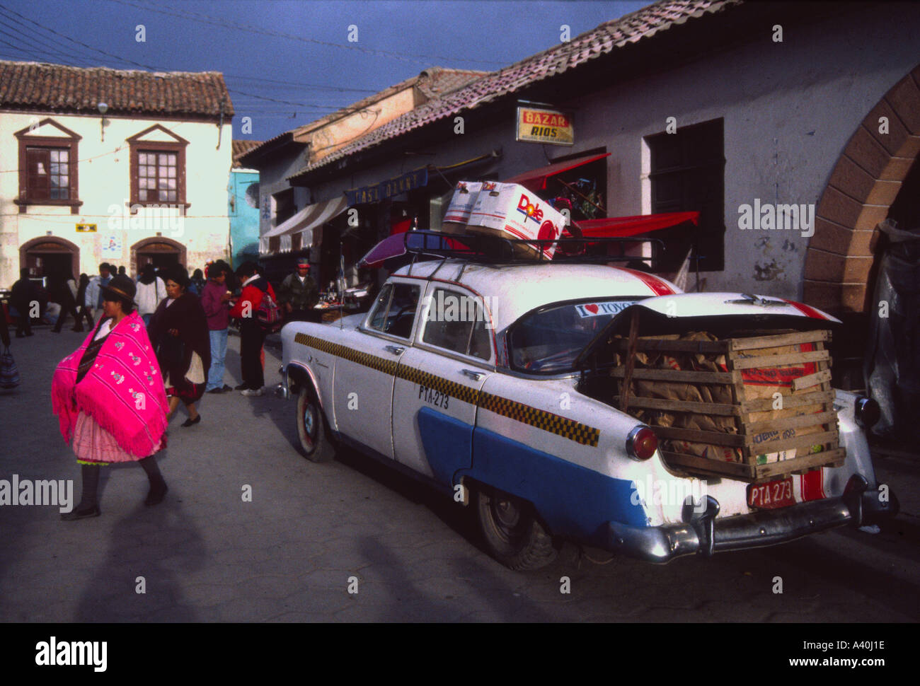 Bolivia Potosi street scene Woman wearing tradition pink shawl and huge