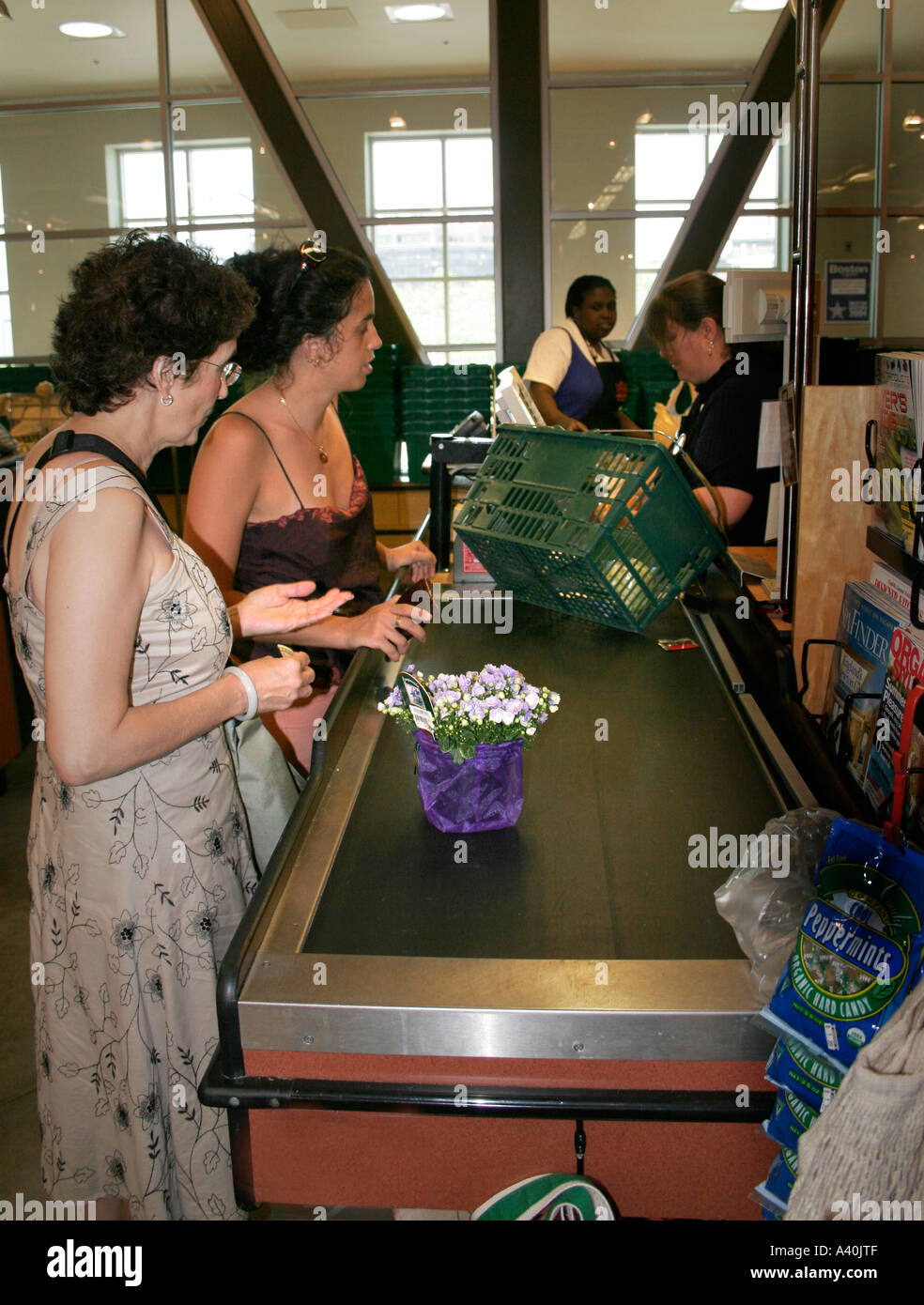 Women shopping in a market, a Mother and Daughter at the checkout after shopping in a USA food market Stock Photo