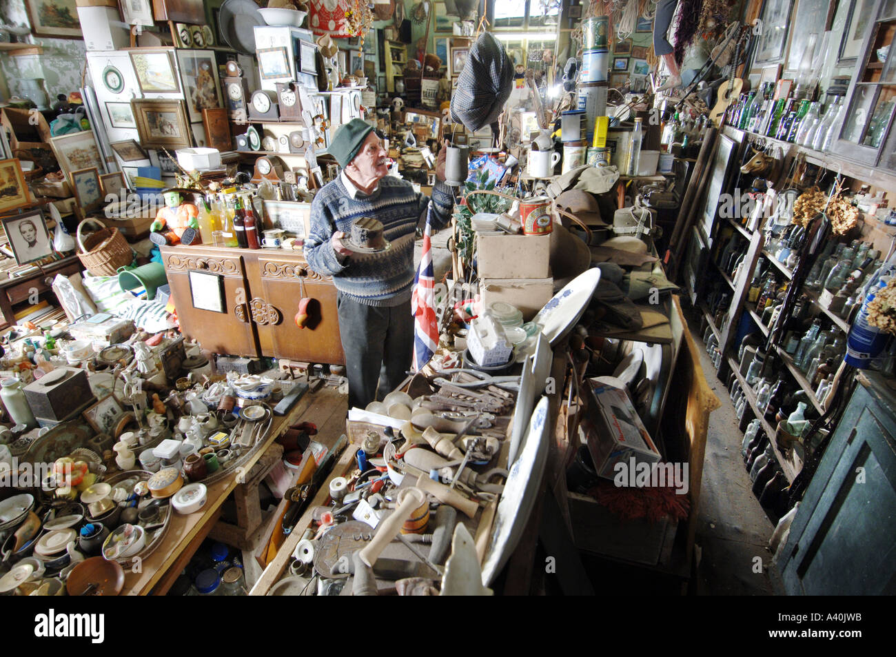 Old man with the thousands of possessions he has hoarded over many decades of never throwing anything away. Stock Photo