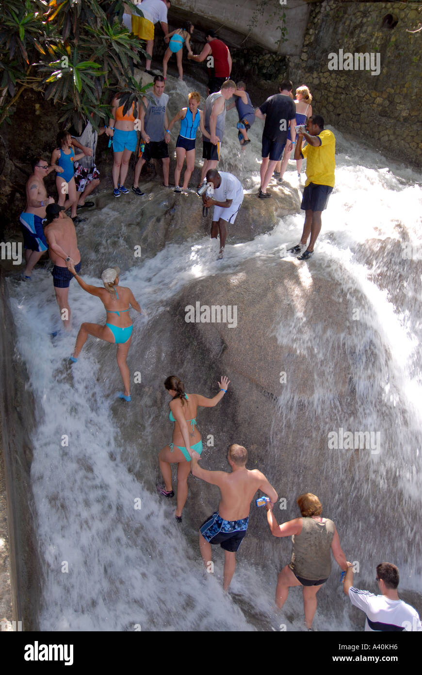 Holidaymakers climbing Dunns River Falls Ocho Rios Jamaica Stock Photo