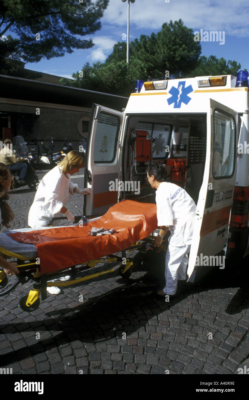 Italian ambulance crew taking a stretcher out of an ambulance Florence Stock Photo