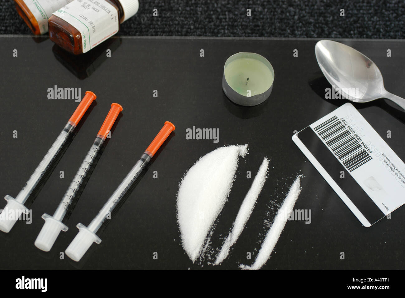 Drug Users Syringe and other equipment to help feed their habit. Stock Photo