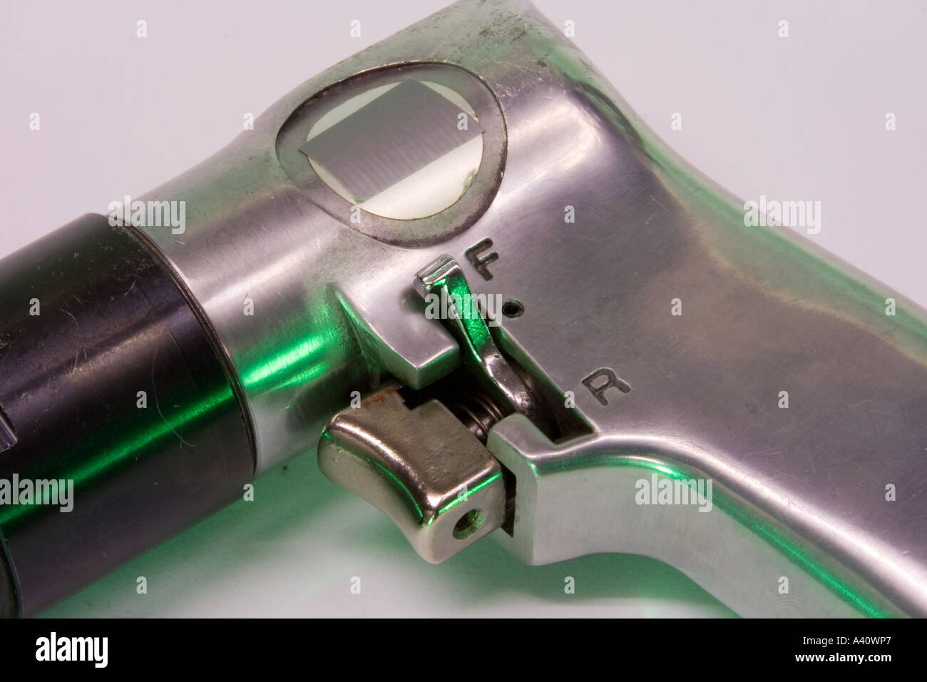 Trigger of compressed air powered drill. Green lighting Stock Photo Alamy