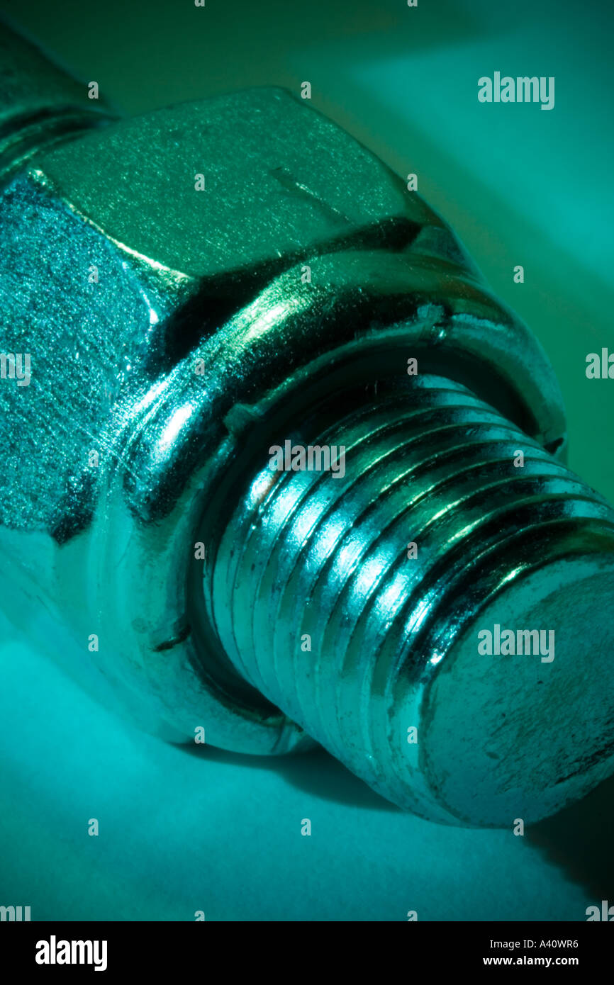 Threads of bolt protruding from nyloc locking nut, lit cool green Stock ...