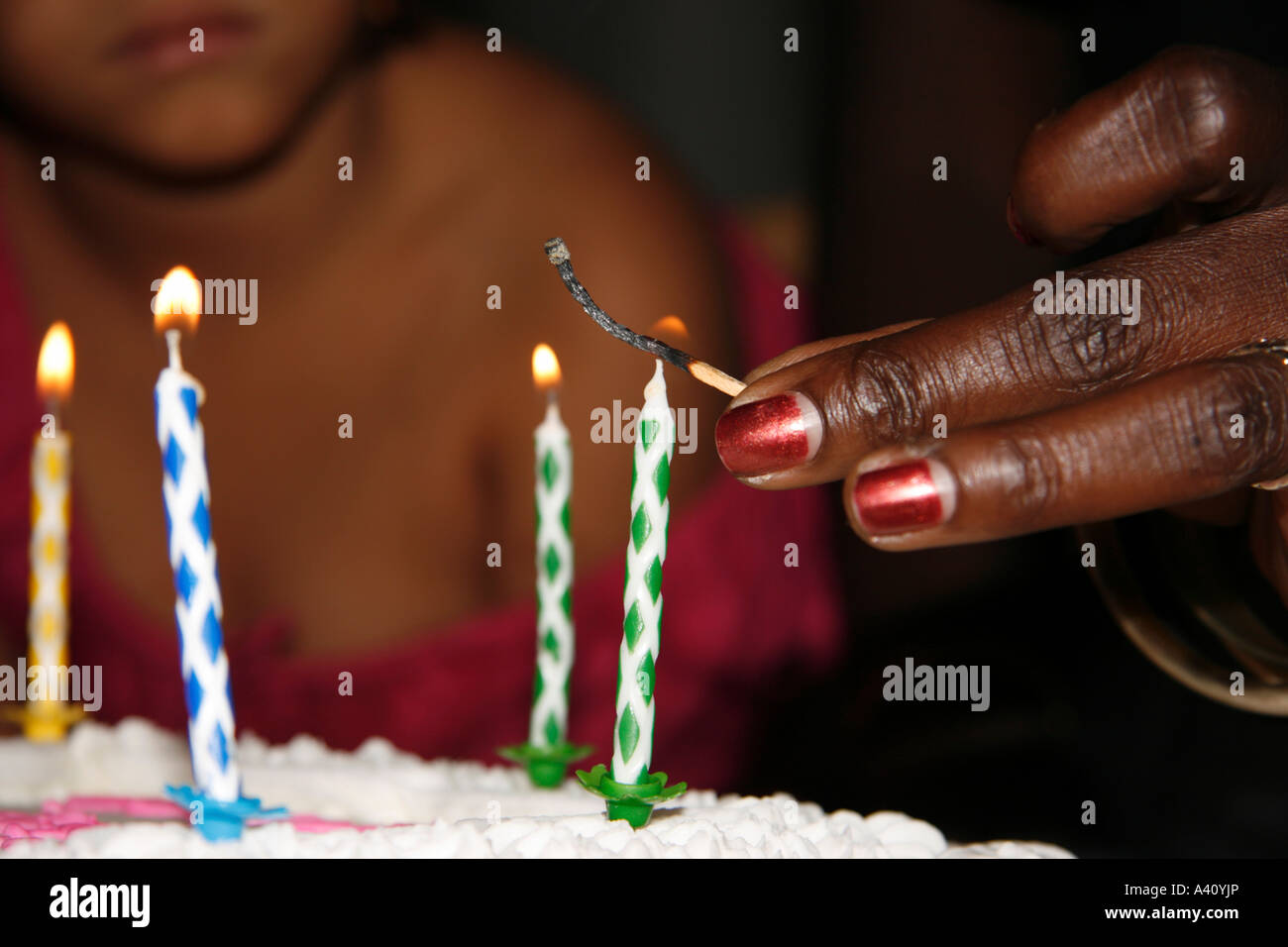 Lighting a birthday cake candle Stock Photo Alamy