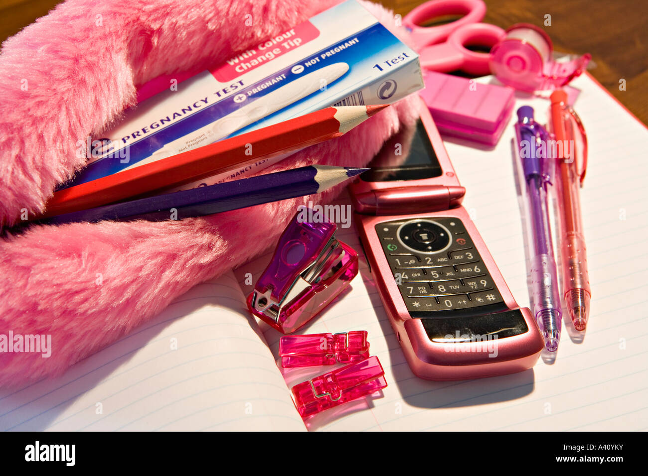Pregnancy testing kit amongst contents of schoolgirl pencil case Stock Photo