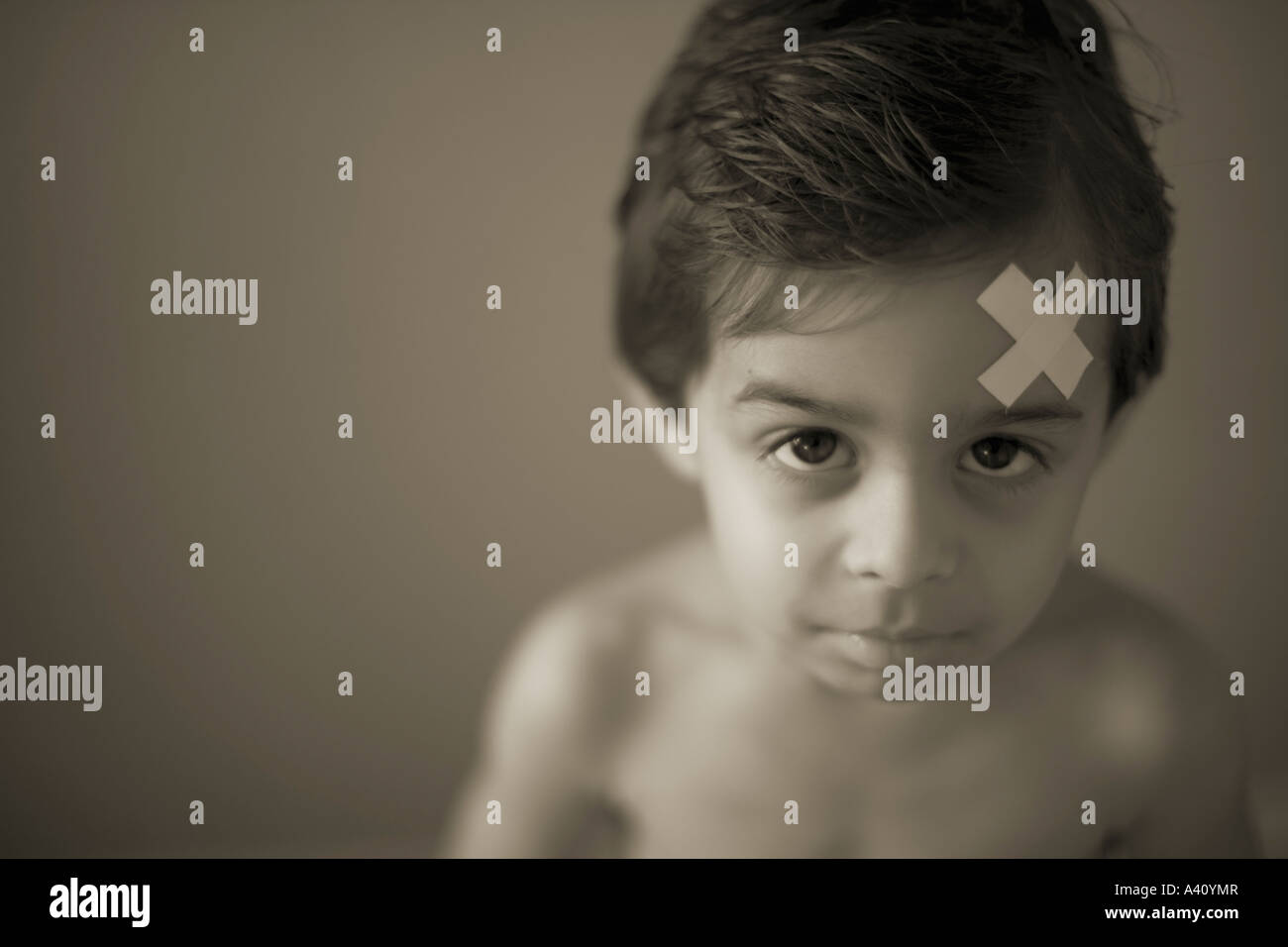 Boy with band aid stuck to forehead Stock Photo Alamy