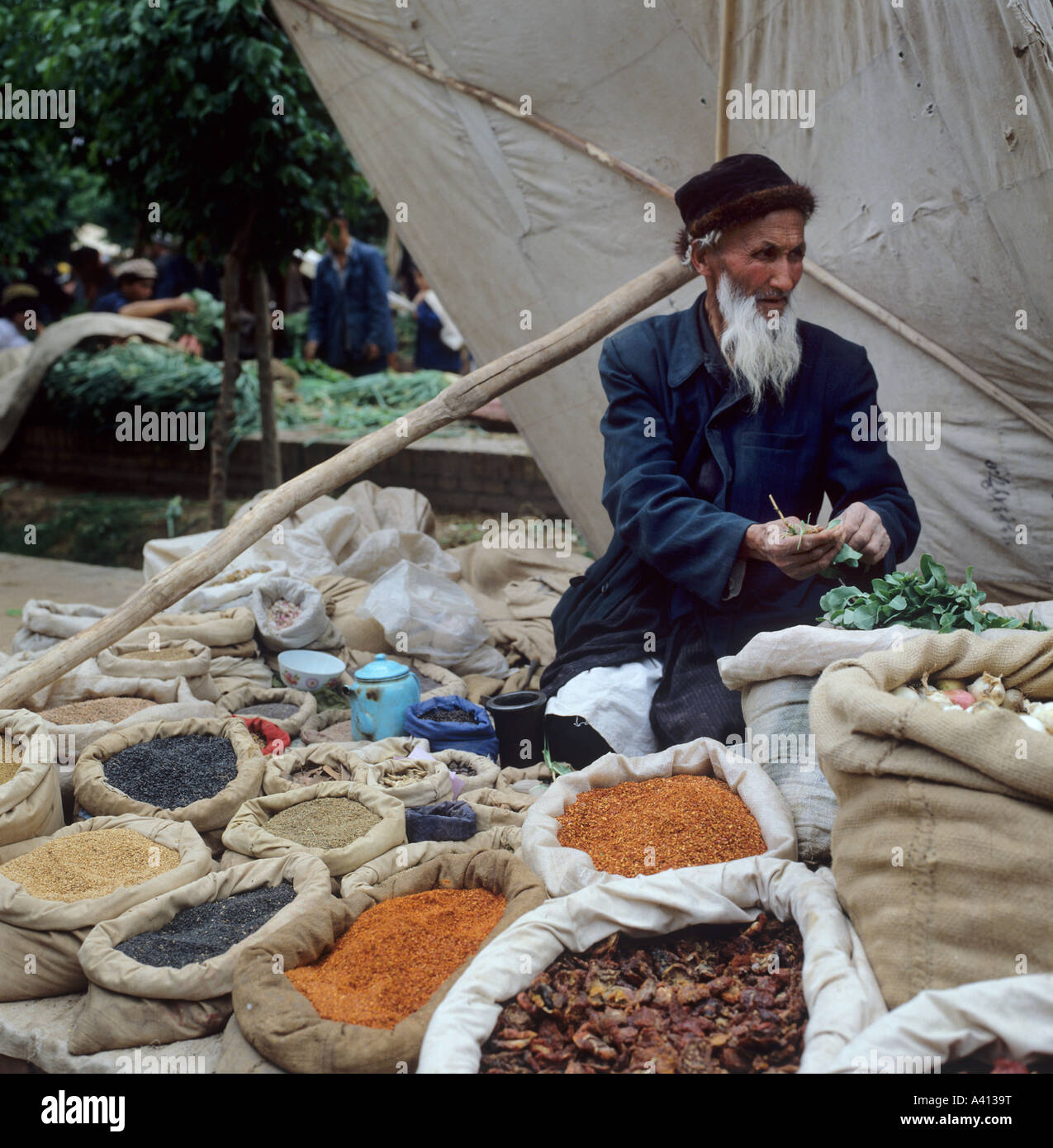 Man selling spices in Kashgar market, Silk Road, China Stock Photo