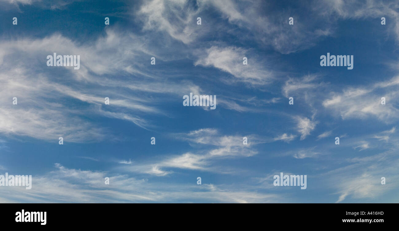 Blue sky with fluffy white clouds in a swirling pattern Stock Photo - Alamy