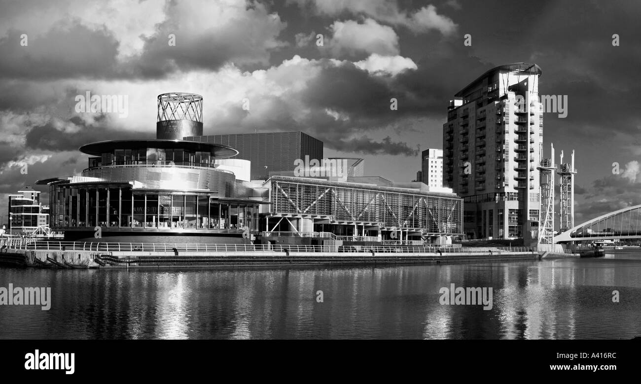 Panorama of the Manchester Ship Canal with the Lowry Centre art gallery theatre and footbridge Salford Quays Greater Manchester Stock Photo