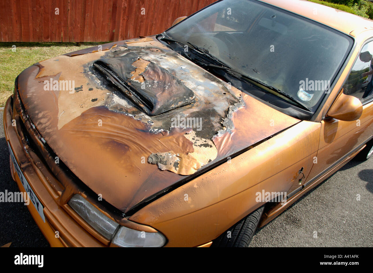 Bonnet of burnt out Vauxhall Astra custom car result of arson attack UK Stock Photo