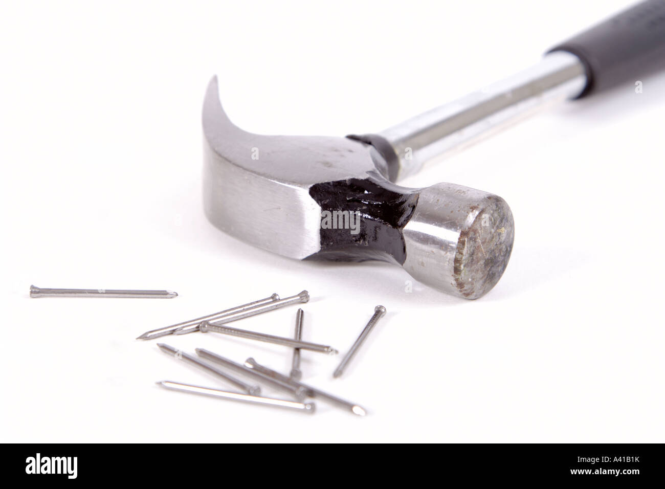 Metal hammer with nails on a white background Stock Photo - Alamy