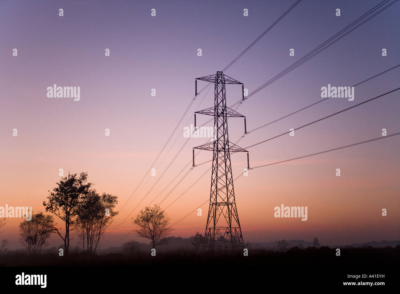 Silhouetted Electricity Pylon at sunset Stock Photo - Alamy