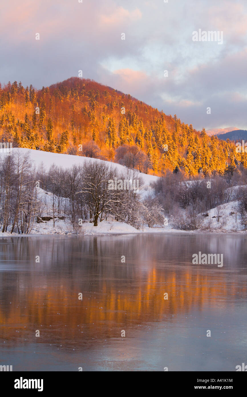 Cold and hot intensive early morning sunrise light on Mrzla vodica lake in Croatia, Europe snowy more or less even in on at probably probable but near Stock Photo