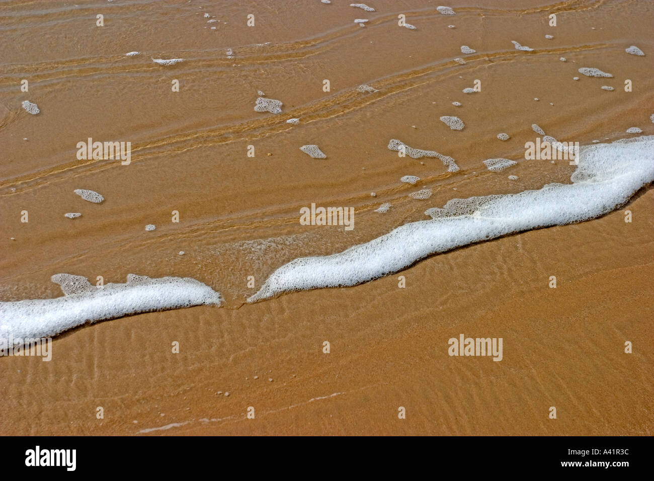 waves over sand in french beach Stock Photo Alamy