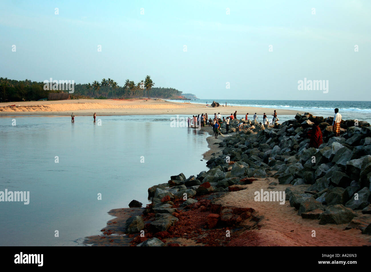 Varkala beach in the evening with fishermen and tourists in picture Stock Photo