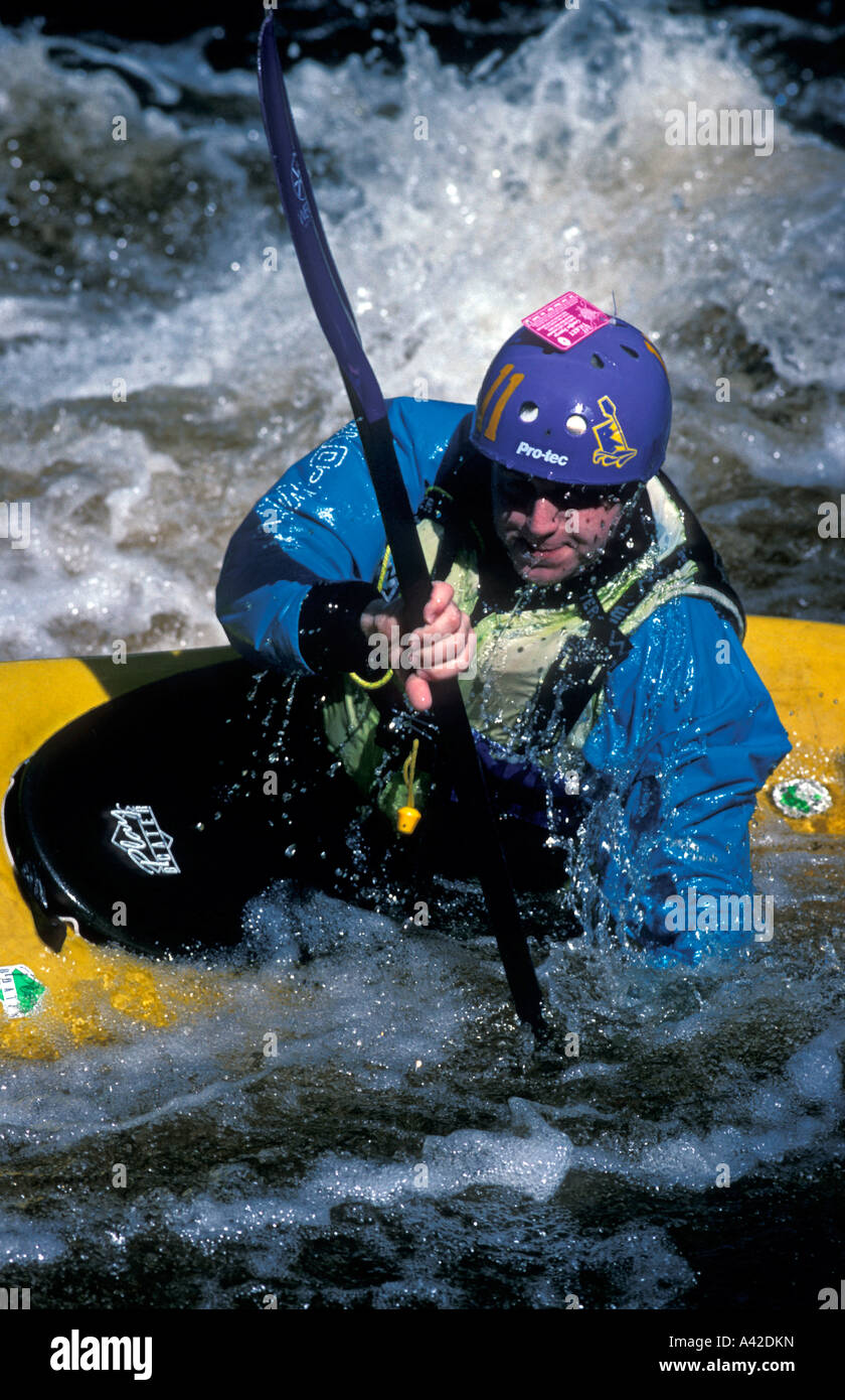 Canoeist coming up from a roll in a fast moving river in the UK Stock Photo