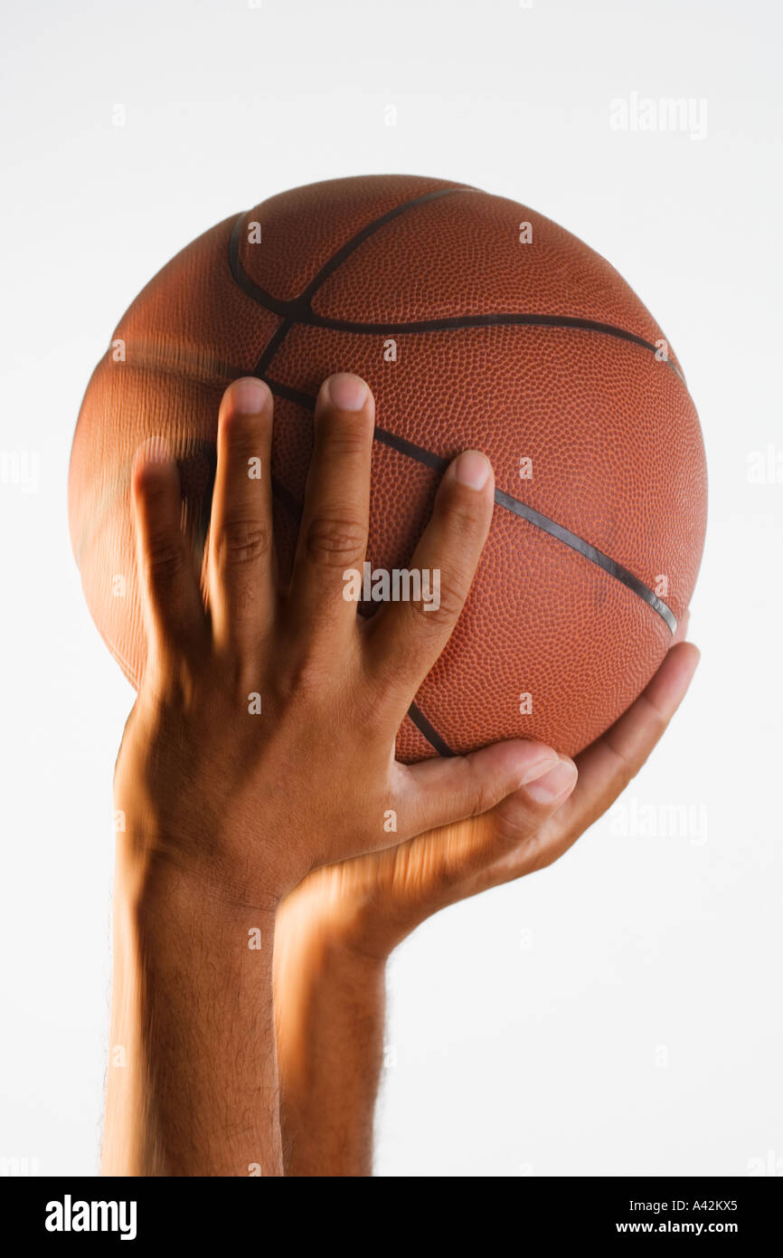Close up of hand holding basketball in air Stock Photo Alamy
