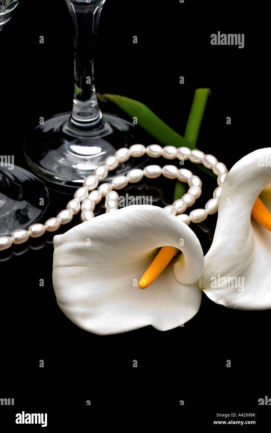 White Calla lilies with glasses and pearls, wedding concept Stock Photo
