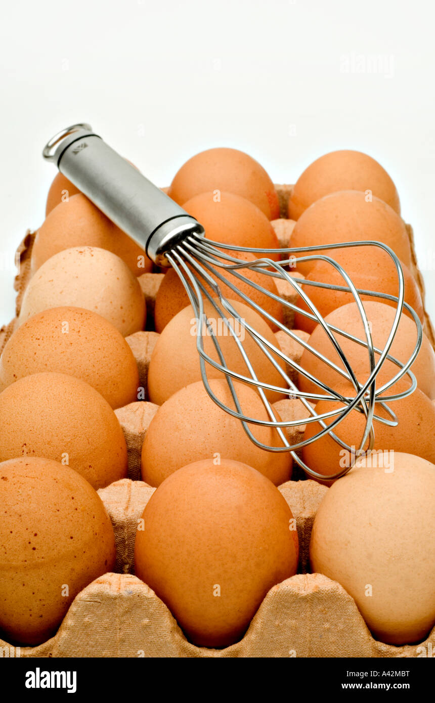 Chickens Eggs with egg beater on white background Stock Photo